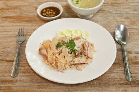 Photo for Steam Chicken with Rice (Hainan Chicken) on wood table background. - Royalty Free Image