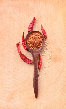 Photo for Dried red chili pepper on wood. Wooden spoon pepper on wooden background.top view. - Royalty Free Image