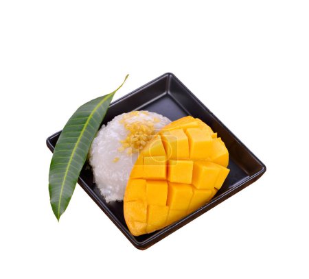 Photo for Thai Mango Sticky Rice with freshly sliced mangoes on a black plate. - Royalty Free Image