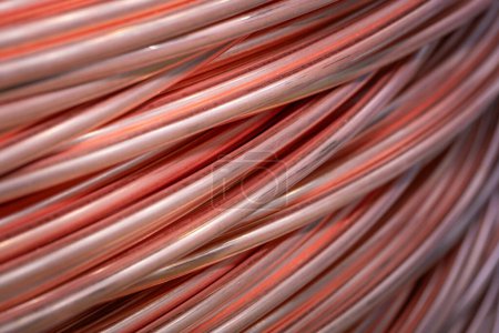 Twisted copper cable, close-up. Closeup of spiral copper cable with soft focus background. Copper wire randomly wound into a coil.