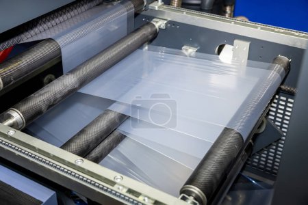 Industrial line for the production of transparent polyethylene film. Transparent film production process. Machines for the production of transparent film in industrial settings.