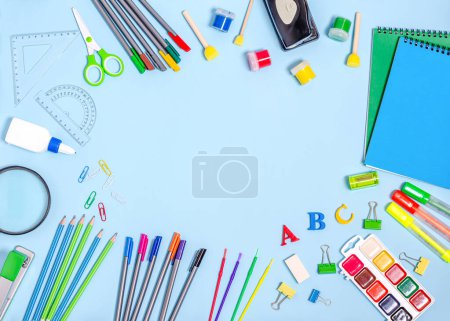 Photo for Training and creativity stationery on a blue background with place for text. School preparation concept, flat lay, copy space. View from above. - Royalty Free Image