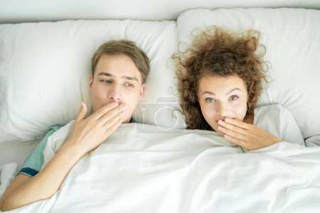 Photo for Love couple lying on white bed, honeymoon and love concept - Royalty Free Image