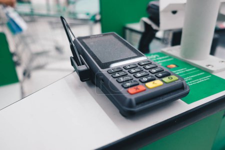 Photo for Credit card reader machine in supermarket, close up - Royalty Free Image