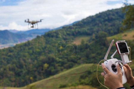 Tourist asian women flying drone on mountain forest vacation in nature