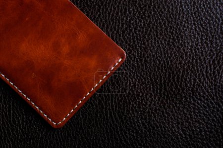 Photo for Brown genuine leather wallet on cowhide background, Craftsmanship object - Royalty Free Image