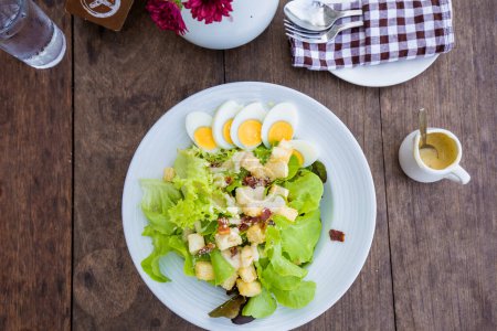 Photo for Caesar salad, healthy food on wooden table - Royalty Free Image