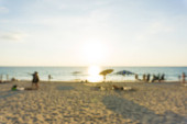 Abstract blurred people relaxing on sea beach at sunset. Summer vacation background  Poster #668499968
