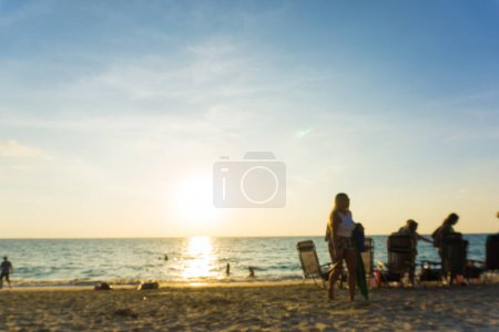 Photo for Abstract blurred people relaxing on sea beach at sunset. Summer vacation background - Royalty Free Image