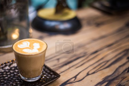 Foto de Café caliente del arte del latte en la tabla de madera con la bebida de cafeína del aroma de la textura de la flor - Imagen libre de derechos