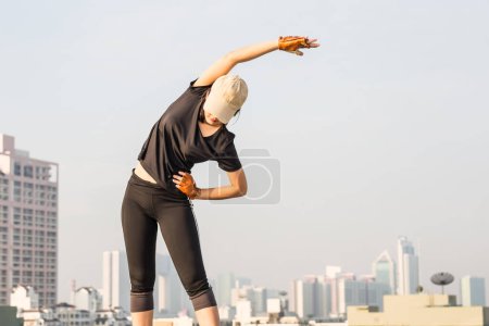 Photo for Smiling sport asian woman stretching for fitness on the top of building, Women doing exercise - Royalty Free Image
