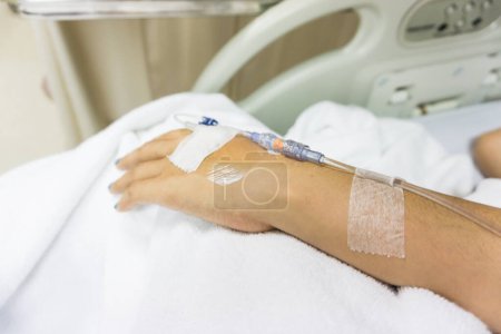 Photo for Sickness of hands with intravenous to patient's on white blanket - Royalty Free Image