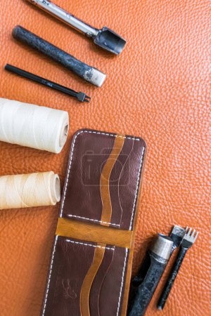 Photo for Leather craft for wallet working with tool on leather craftman's work desk . - Royalty Free Image