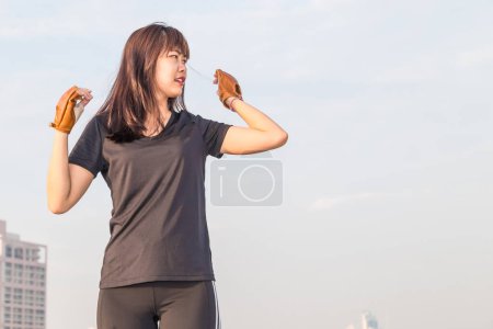 Photo for Asian woman fitness sunrise stretch before jogging workout wellness concept building background. - Royalty Free Image