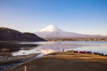 Photo for Fujisan mountain reflection on water with boat morning sunrise  kawaguchiko lake snow landscape, Japan - Royalty Free Image