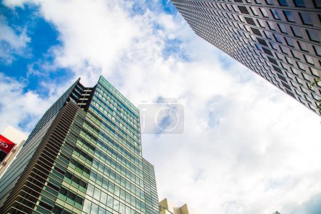 Photo for Window office building in Tokyo city against blue sky with cloud uprise view - Royalty Free Image