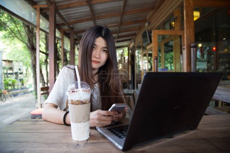 Photo for Beautiful hipster student woman using laptop and drinking coffee at cafe - Royalty Free Image