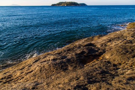 Téléchargez les photos : Mer vague éclaboussure sur plage rocheuse journée ensoleillée matin lever du soleil mer d'Andaman - en image libre de droit