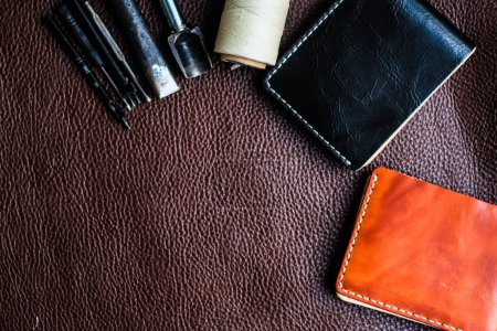 Photo for Tool making genuine leather wallet craftsmanship workshop flatlay on cowhide - Royalty Free Image