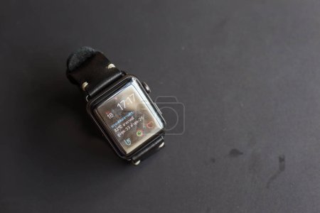 Foto de Correa de reloj de cuero genuino con reloj inteligente sobre fondo negro - Imagen libre de derechos