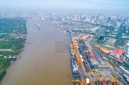Photo for Container cargo ship with working crane bridge in shipping import export business logistic and transportation, Aerial view - Royalty Free Image