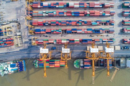 Photo for Container cargo ship with working crane bridge in shipping import export business logistic and transportation, Aerial view - Royalty Free Image