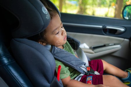 Photo for Happy preschool girl sitting in carseat - Royalty Free Image