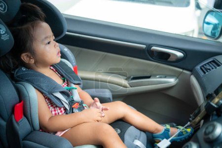 Photo for Happy preschool girl sitting in carseat - Royalty Free Image