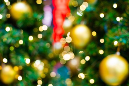 Photo for Golden christmas ball on pine tree branch green leaf blurred bokeh background merry christmas - Royalty Free Image