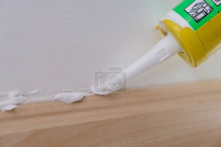 Photo for Mechanical man hand use wood floor sealance interior building design - Royalty Free Image