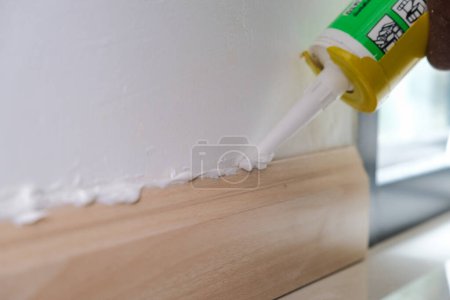 Photo for Mechanical man hand use wood floor sealance interior building design - Royalty Free Image