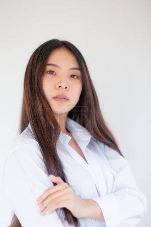 Foto de Portrait of beautiful young asian pretty woman white collar shirt on white background in studio - Imagen libre de derechos