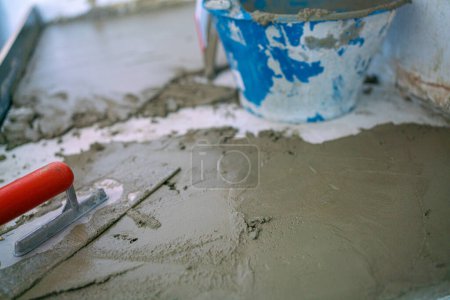 Photo for Mechanical man hand plaering cement interior floor building house renovate - Royalty Free Image