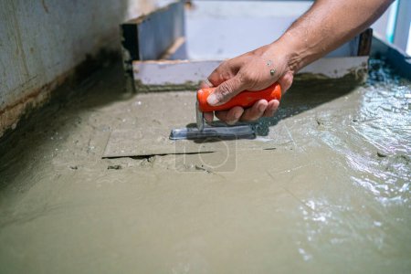 Photo for Mechanical man hand working with cement - Royalty Free Image