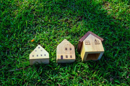 Photo for Wooden toy house on nature green grass resident business object real estate industry - Royalty Free Image