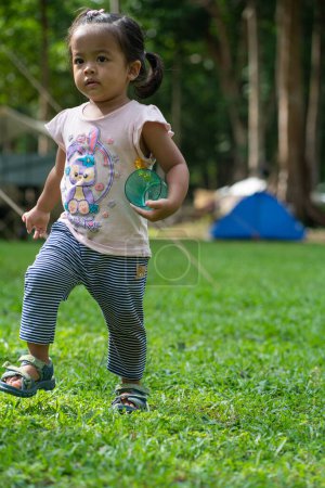 Photo for Little asian girl enjoying with camping site in mountain forest outdoor activity - Royalty Free Image