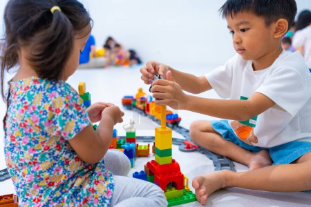 Photo for Adorable little child boy and girl playing plastic block toy building imagination education concept - Royalty Free Image