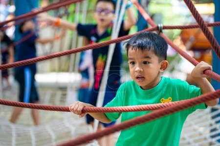 Photo for Kindergarten asian boy enjoying in city outdoor playground happy vacation learnning and exercise - Royalty Free Image