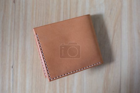 Foto de Genuine leather bifold money wallet with crafts tool craftmanship working - Imagen libre de derechos