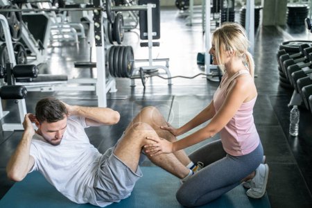 Photo for Sport couple sit up together in fitness gym man and woman exercise together - Royalty Free Image