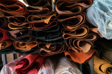 Photo for Colorful raw genuine vegetable tanned leather on shelf in crafts shop, Handmade market - Royalty Free Image