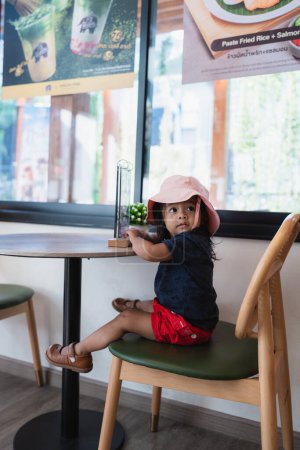 Photo for Adorable asian 3 year kid enjoying in coffee shop kid play in cafe - Royalty Free Image