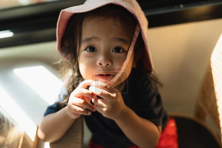 Photo for Adorable asian 3 year kid enjoying in coffee shop kid play in cafe - Royalty Free Image