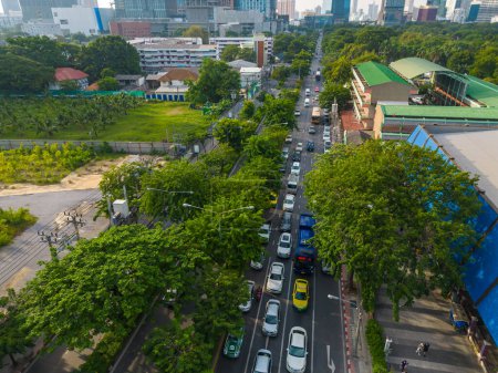Photo for Aerial view of Lumphini Park backgrounded by the Silom area skyline office building business district of Thailand's capital. - Royalty Free Image
