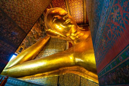 Photo for Golden big reclining buddhist statue in temple sightseeing in Bangkok thailand - Royalty Free Image