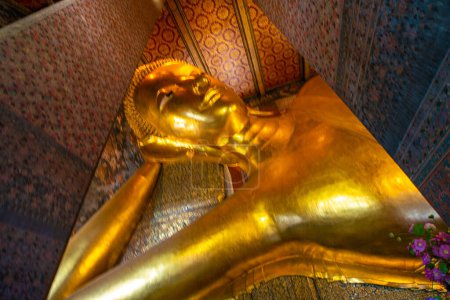 Photo for Golden big reclining buddhist statue in temple sightseeing in Bangkok thailand - Royalty Free Image