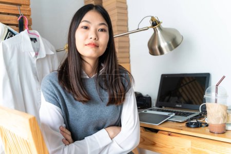 Young pretty asian business woman with notebook in the home office