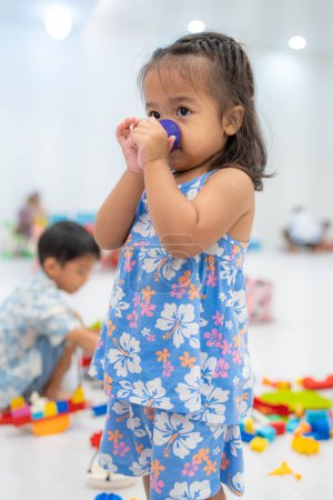 Photo for Cute asian little girl playing with colorful toy blocks at kindergarten daycare, Toddler kid in nursery. - Royalty Free Image