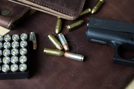 Photo for 9mm Sub compact everday carry modern gun with bullet on leather background, Pocket gun - Royalty Free Image