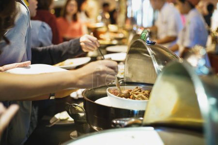 Téléchargez les photos : Personnes groupe séminaire main saisir la nourriture buffet dans le restaurant après le séminaire chambre d'hôtel - en image libre de droit